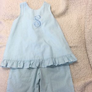 Blue and white outfit with S monogram.